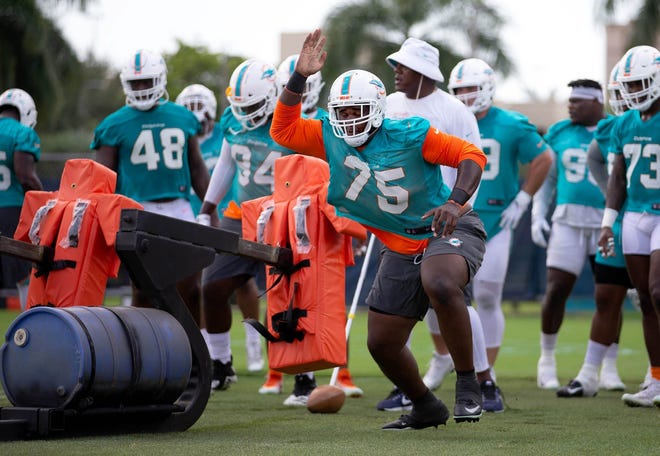 Dolphins defensive tackle Kendrick Norton (75), shown during offseason workouts at the team's training facility in Davie last month, remains in good spirits despite losing his left arm following an auto accident. [ALLEN EYESTONE/palmbeachpost.com]