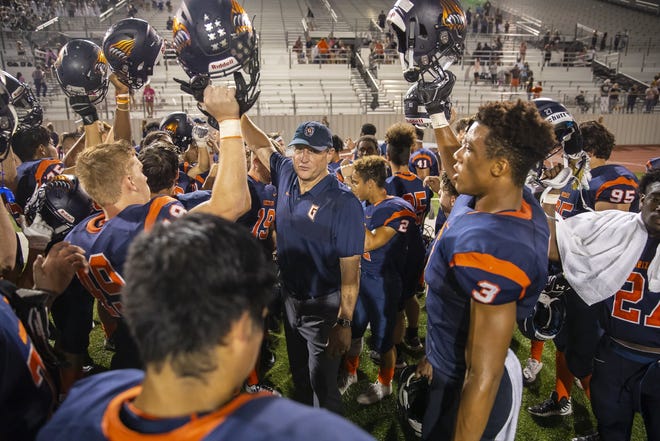 Glenn football coach Rob Shoenfeld leads the team cheer after a win over Weiss last season. Glenn became the first football program in the Austin area to win a district title in its first varsity season. [JOHN GUTIERREZ/FOR STATESMAN]