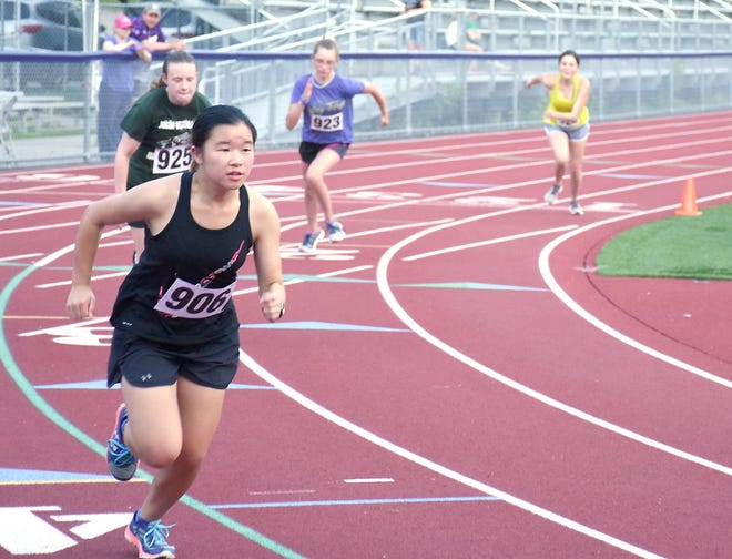 Alexis Hong (906) sets out with three other runners in the girls' divisions of the Don Taylor Memorial Run Tuesday on the Central Valley Academy track in Ilion. [JON RATHBUN/TIMES TELEGRAM]