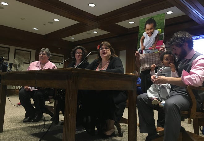 Rep. Colleen Garry filed a bill to require window guards in the homes of young children after 2-year-old Zella-Ray Martin fell to her death out of an apartment window. The Martin family joined Garry on Thursday to testify for the bill. [Photo: Katie Lannan/SHNS]