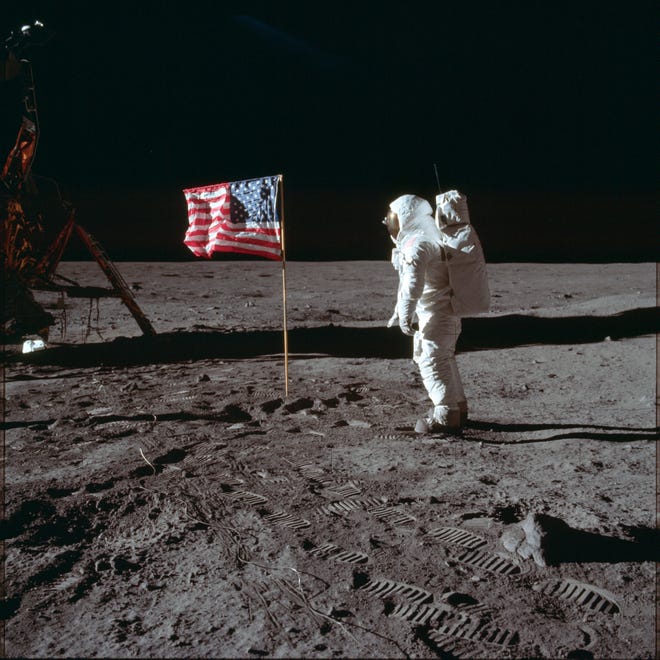 In this July 20, 1969 photo made available by NASA, astronaut Buzz Aldrin Jr. poses for a photograph beside the U.S. flag on the moon during the Apollo 11 mission. Aldrin and fellow astronaut Neil Armstrong were the first men to walk on the lunar surface with temperatures ranging from 243 degrees above to 279 degrees below zero. Astronaut Michael Collins flew the command module. (Neil Armstrong/NASA via AP)