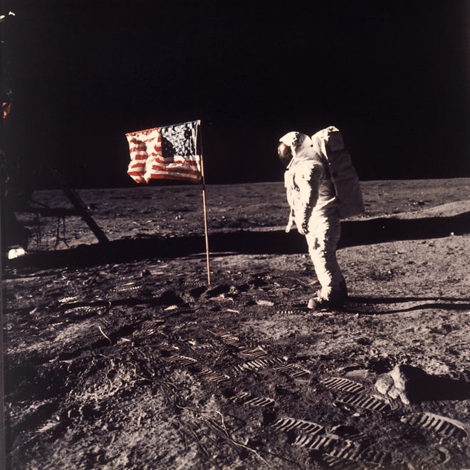 In this image provided by NASA, astronaut Buzz Aldrin poses for a photograph beside the U.S. flag deployed on the moon during the Apollo 11 mission on July 20, 1969. [Neil A. Armstrong/NASA via AP]
