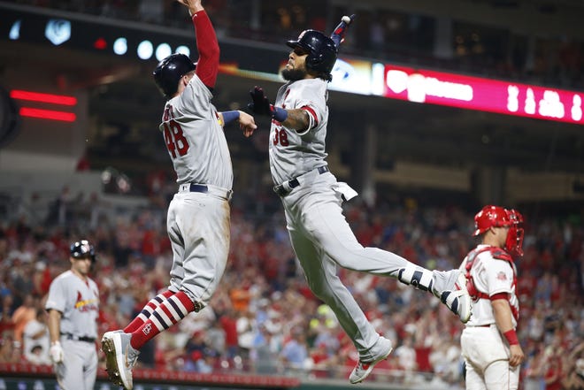 St. Louis Cardinals' Jose Martinez, right, and Harrison Bader (48) celebrate Martinez's three-run home run off Cincinnati Reds relief pitcher Jared Hughes during the sixth inning of a baseball game Friday, July 19, 2019, in Cincinnati. (AP Photo/Gary Landers)