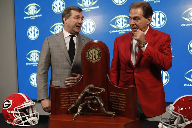 Georgia coach Kirby Smart and Alabama coach Nick Saban pose for a photo with the Southeastern Conference Championship trophy on Nov. 30, 2018, one day before the SEC title game in Atlanta. [JOSHUA L. JONES/ATHENS BANNER-HERALD FILE PHOTO]