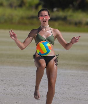 Drew Smith, on vacation from Ontario, practices her soccer moves on Siesta Key Beach Wednesda. [DAN WAGNER/HERALD-TRIBUNE]
