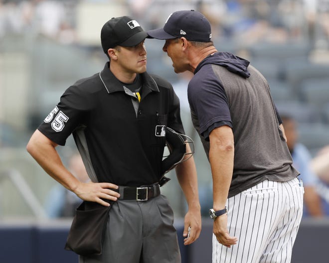 New York Yankees manager Aaron Boone gets in the face of home plate umpire Brennan Miller during Thursday's doubleheader. It was Miller's fifth game behind the plate. [THE ASSOCIATED PRESS]