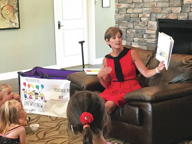 Gov. Kim Reynolds reads to area kids during Waukee Schools Nutrition department’s Picnic and Play summer meal meet up program on Friday, July 12. PHOTO COURTESY WAUKEE CSD
