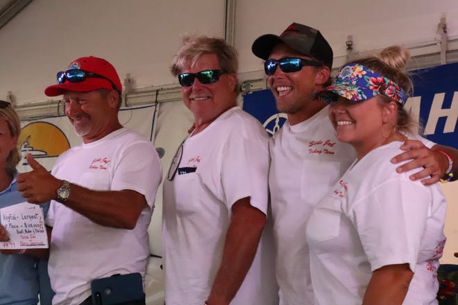 [From left] Side Job captain Chris Jonsson, Earl Jonsson, Bryce Jonsson and Taylor Jonsson receive their prize at the award ceremony for the Greater Jacksonville Kingfish Tournament. [Clayton Freeman/Florida Times-Union]