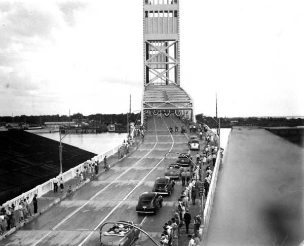 Spectators line the Main Street Bridge as cars carrying local and state dignitaries in a parade marking the grand opening of the bridge on July 18, 1941, in downtown Jacksonville. [State Archives of Florida]