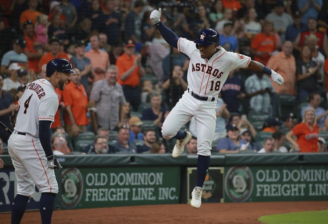 Houston Astros' Tony Kemp (18) celebrates his solo home run against the Texas Rangers as teammate George Springer (4) looks on in the sixth inning of a baseball game Saturday in Houston. [AP Photo/Richard Carson]