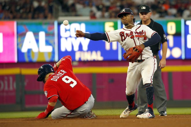 Braves second baseman Ozzie Albies (1) throws to first to complete the double play after forcing out the Washington Nationals' Brian Dozier (9) on a Kurt Suzuki ground ball in the fourth inning Saturday in Atlanta. [JOHN BAZEMORE/THE ASSOCIATED PRESS]