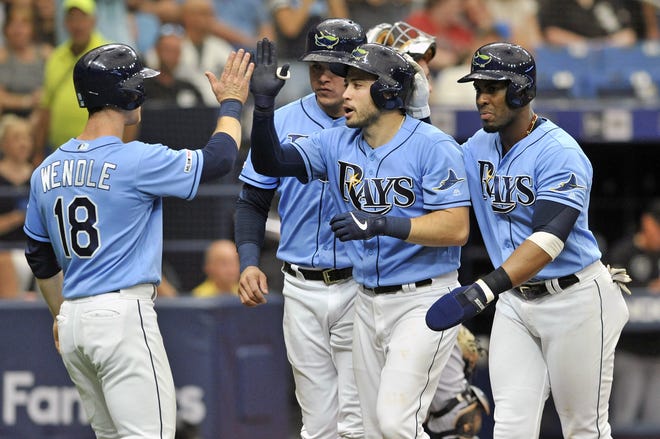 From left to right, Tampa Bay Rays' Joey Wendle, Avisail Garcia, Travis d'Arnaud and Yandy Diaz celebrate d'Arnaud's grand slam off Chicago White Sox starter Dylan Cease during the second inning Sunday. [STEVE NESIUS/THE ASSOCIATED PRESS]