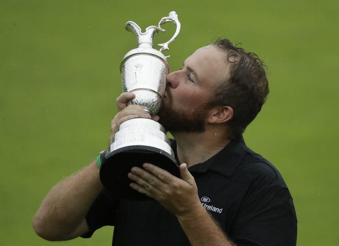 Ireland's Shane Lowry holds and kisses the claret jug trophy after winning the British Open on Sunday at Royal Portrush in Northern Ireland. [MATT DUNHAM/THE ASSOCIATED PRESS]