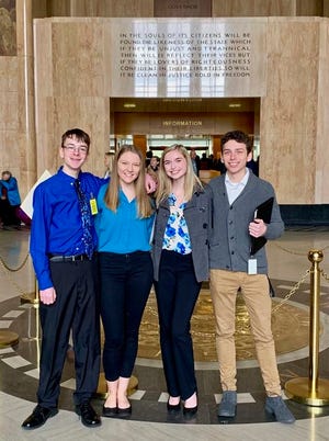 In this Feb. 6, 2019 photo provided by Providence Health & Services, from left, Sam Adamson, Lori Riddle, Hailey Hardcastle, and Derek Evans pose at the Oregon State Capitol in Salem, Ore. The teens introduced legislation to allow students to take "mental health days" as they would sick days in an attempt to respond to a mental health crisis gripping the state. (Jessica Adamson/Providence Health & Services via AP)