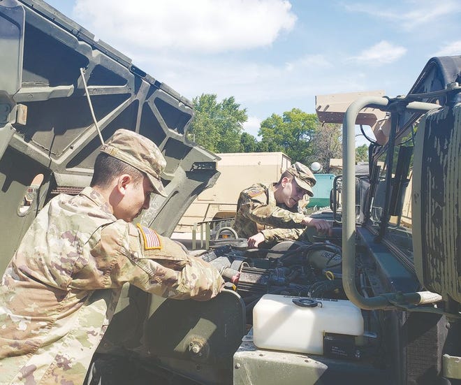 PFC Jacob Weller, left, and SPC Shea Fredrickson perform maintenance on one of the trucks at the Kewanee Army National Guard. The two are currently on active duty at the Armory and both were born and raised in Kewanee.