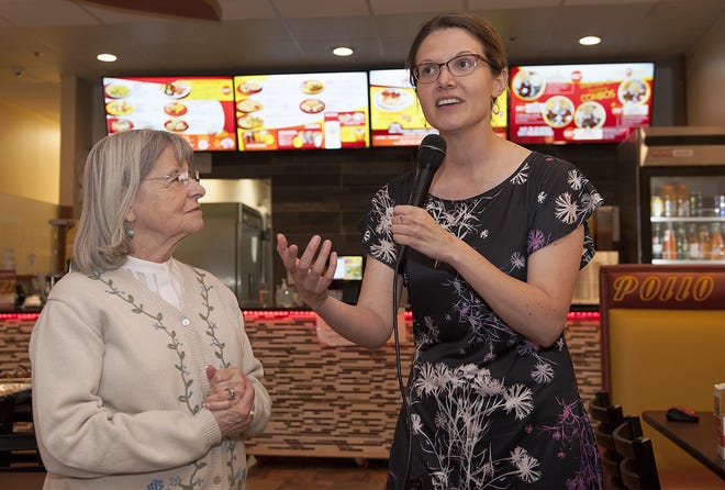 Courtney Thraen, right, executive director of Downtown Framingham Inc., speaks at a Burkis Square Betterment Support Night community meeting at the Pollo Royal restaurant. At left is District 8 City Councilor Judy Grove. [Daily News and Wicked Local Staff Photo / Art Illman]