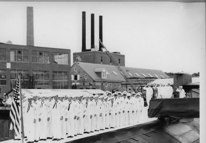 Officers and crew salute the colors aboard USS Thresher (SSN 593) on Aug. 3, 1961, outside Building 5 at Portsmouth Naval Shipyard. Thresher was lost at sea April 10, 1963, claiming the lives of all 129 men on board. [US Navy photo]