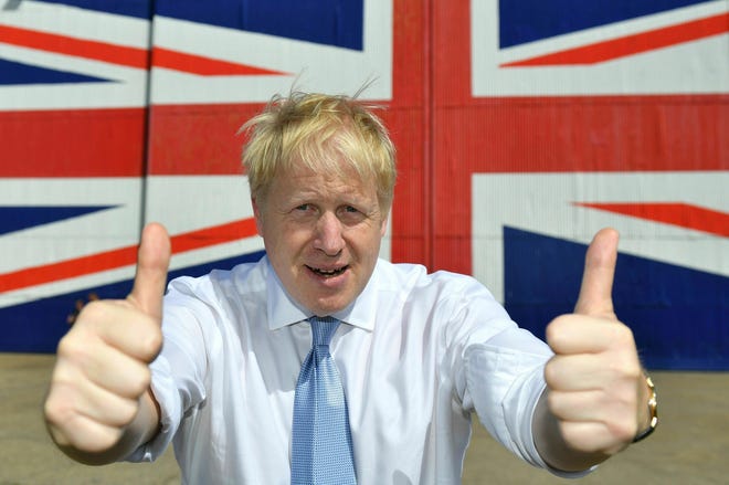 FILE - In this Thursday, June 27, 2019 file photo Conservative leadership candidate Boris Johnson gives the thumbs at the Wight Shipyard Company at Venture Quay during a visit to the Isle of Wight, England. (Dominic Lipinski/Pool Photo via AP, File)