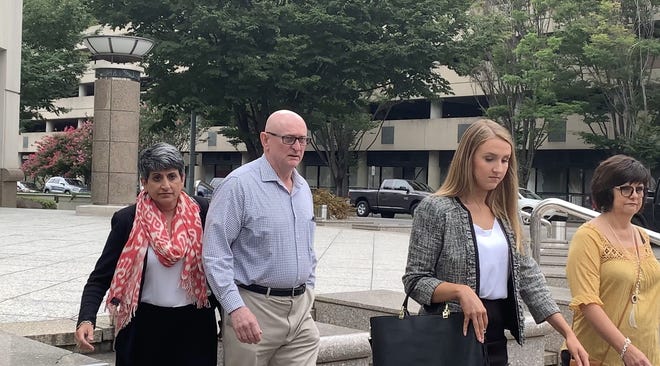 David Abston leaves the Hugo Black Courthouse in Birmingham on Tuesday, July 23, 2019, with his attorney, Augusta Dowd, left, and his wife, Debra, far right. [Staff photo/Stephanie Taylor]