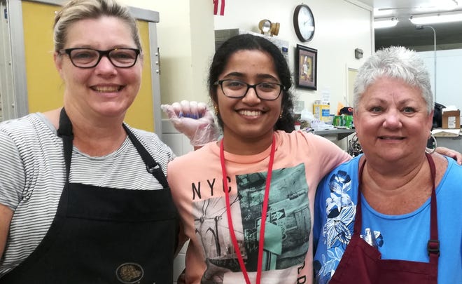 From left, staff member Tracy O'Neil, student volunteer Meghana Vadassery, and volunteer Ann Sech pose for a photo while working in the Chelmsford Senior Center kitchen. The town is looking for ways to make services and facilities more age-friendly for residents of all generations. [Courtesy Photo/Chelmsford Senior Center]