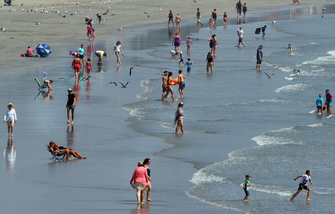 People enjoy the water at Easton's Beach in Newport on a warm summer afternoon in 2018. [PROVIDENCE JOURNAL FILE PHOTO]