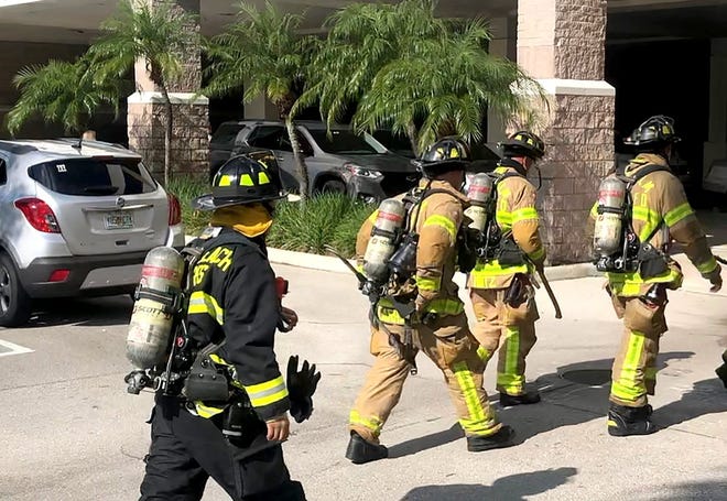 West Palm Beach Fire Rescue firefighters enter The Palm Beach Pos building at Belvedere Road and South Dixie Highway on Wednesday, July 24, 2019. An overheated motor in a freight elevator started to give off smoke, sounding the alarm. [ANNETTE JONES/palmbeachpost.com]