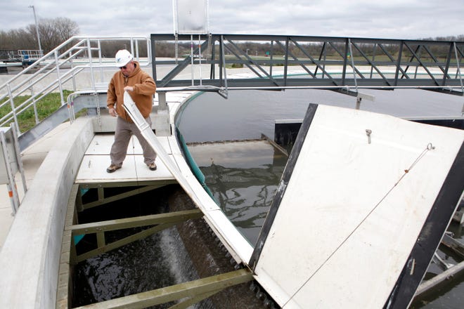 Gregg Humphrey, executive director of the Sangamon County Water Reclamation District, closes a cover on one of the primary clarifiers at the Spring Creek Wastewater Treatment Plant in 2013. [Rich Saal/The State Journal-Register]
