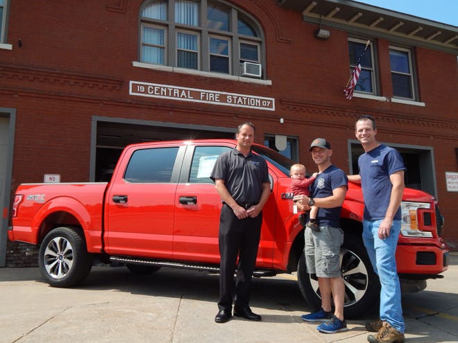 Andy Haapala of Soo Motors visited the Sault Fire Hall on Tuesday with the Ford F-150 that will serve as the prize for the first person to sink a hole in one at an unspecified Par 3 hole at Tanglewood Golf Course during the upcoming scramble in Sault Ste. Marie. Sault Firefighter/ Paramedic Allen Hipps, with son Bryce and Firefighter/ Paramedic Peyton Blakely are using the event to raise funds for the creation of a Sault Ste. Marie Fire Department Honor Guard. (Scott Brand/The Sault News)