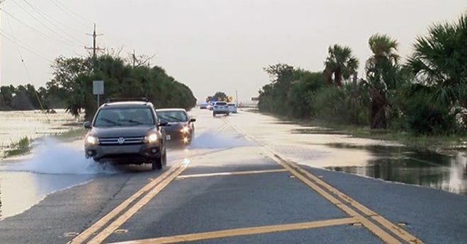 Vehicles navigate flood waters on U.S. 80 in this undated photo from the City of Tybee.