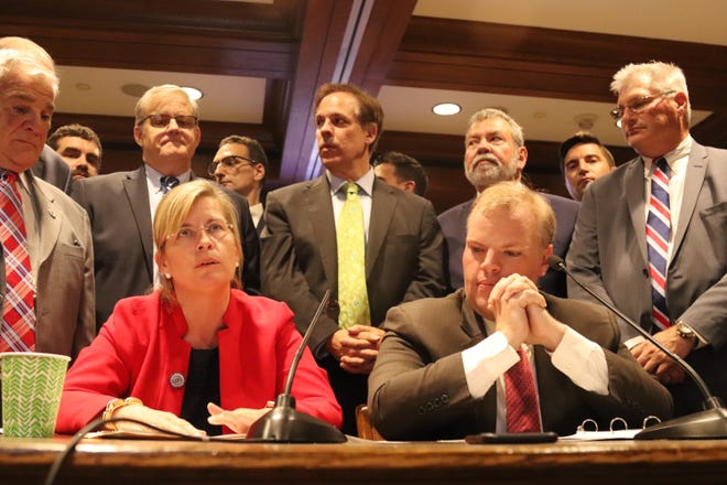 State Rep. Marjorie Decker, D-Cambridge, left, and state Rep. Sean Garballey, D-Arlington, seated at right, testify Tuesday about a bill they introduced to move Massachusetts toward 100 percent renewable energy by 2045. [Photo/Chris Van Buskirk]