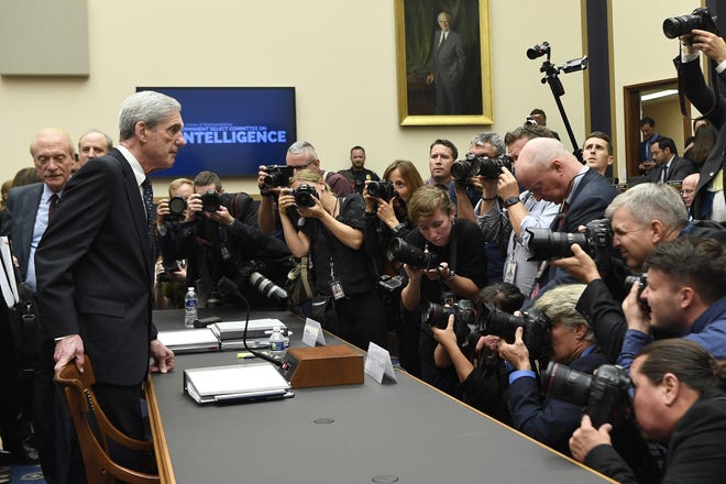 Former special counsel Robert Mueller returns to the witness table following a break in his testimony before the House Intelligence Committee on Capitol Hill in Washington Wednesday. [AP Photo/Susan Walsh]