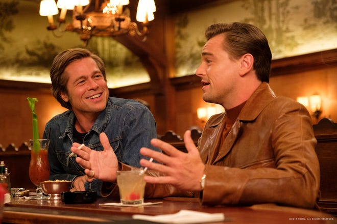 Cliff (Brad Pitt) and Rick (Leonardo DiCaprio) take a moment to forget their worries. [Columbia Pictures]