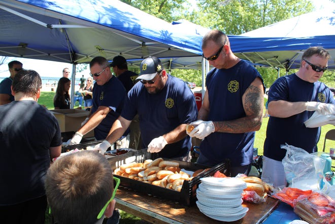 Over 600 hot dogs were passed out by members of the Cheboygan Fire Department Sunday afternoon at their annual Kids Picnic. Photo by Kortny Hahn