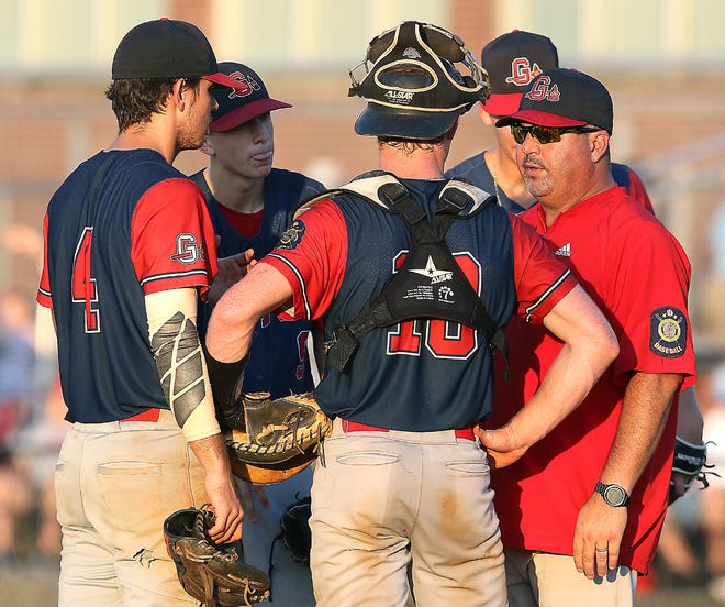 Coach Mark King and Gaston Braves players meet at the mound early during their Area IV title game against Cherryville. [JOHN CLARK/THE GASTON GAZETTE]