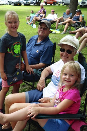 Hannah Prescott, 7, left, and her younger sister, Laura, 5, both of Maxwell, spent some quality time with their grandparents, Paul and Ginny Heintz of Colo, during this year’s Story County Fair. This photo was taken near the dog showing area, where Hannah had shown her dog.