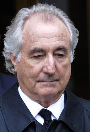 Bernard Madoff exits Manhattan federal court in New York in 2009. Madoff is asking President Donald Trump to commute his 150-year sentence. [AP file photo]