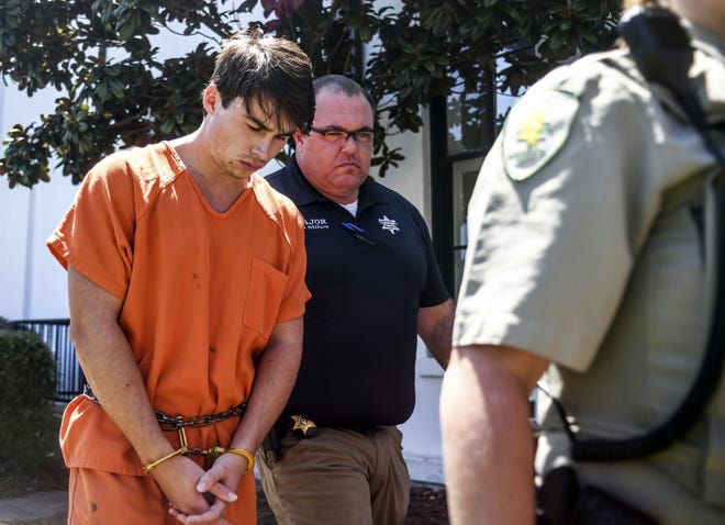 Brandon Theesfeld, left, is led from the Lafayette County Courthouse in Oxford, Miss., Tuesday, July 23, 2019 by Maj. Alan Wilburn, after being arraigned in connection with the death of 21-year-old University of Mississippi student Alexandria "Ally" Kostial. (Bruce Newman/The Oxford Eagle via AP)