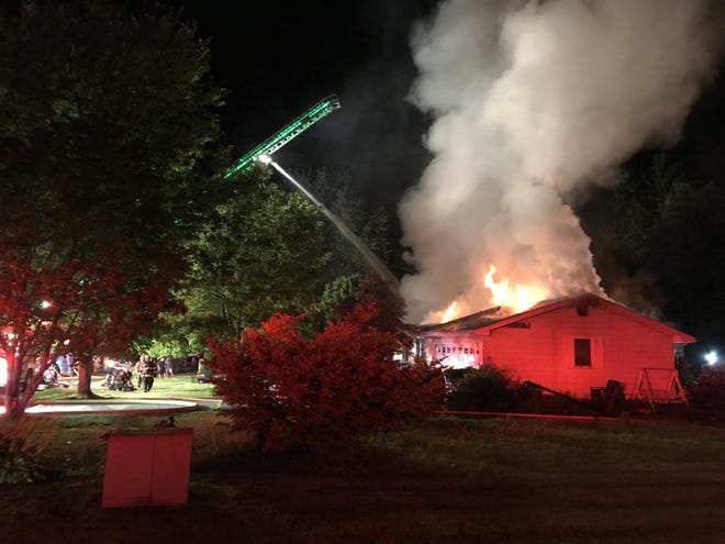 Firefighters battle a house fire on Somerset Drive in Fairview Township on Friday night. [DAVID BRUCE/ERIE TIMES-NEWS]