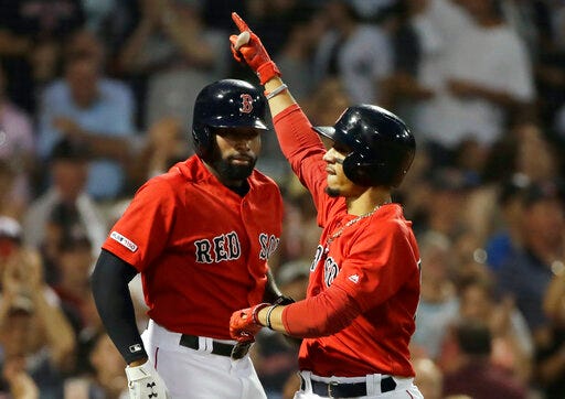 Boston Red Sox's Mookie Betts, right, celebrates his two-run homer with teammate Jackie Bradley Jr. in the fourth inning of a baseball game against the New York Yankees at Fenway Park, Friday, July 26, 2019, in Boston. It was his third home run of the game. (AP Photo/Elise Amendola)