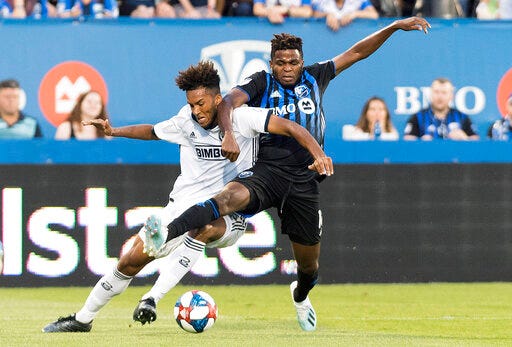 Montreal Impact's Orji Okwonkwo, right, challenges Philadelphia Union's Auston Trusty during the first half of an MLS soccer game, Saturday, July 27, 2019 in Montreal. (Graham Hughes/The Canadian Press via AP)