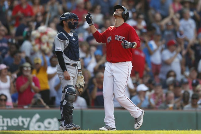 Boston's J.D. Martinez celebrates his two-run homer in front of the Yankees' Kyle Higashioka during the fourth inning Saturday at Fenway Park. [Michael Dwyer/AP]