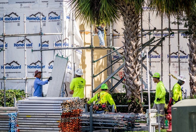 Scaffolding equipment is removed from the San Matera condominium complex in Palm Beach Gardens after a contractor hired to fix water intrusion problems walked off the job in April. Construction has yet to resume. [RICHARD GRAULICH/palmbeachpost.com]