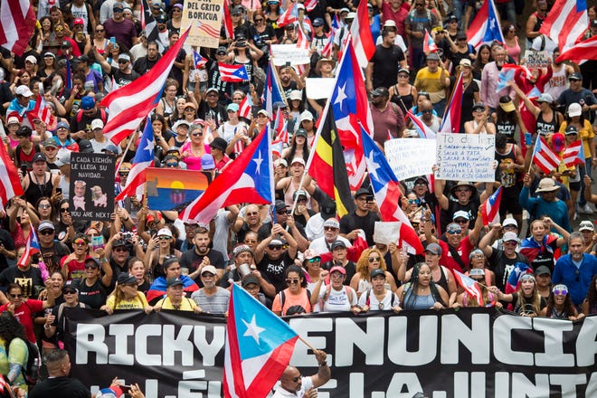 People march Thursday to celebrate the resignation of Gov. Ricardo Rossello who announced overnight that he is resigning Aug. 2 after weeks of protests over leaked obscene, misogynistic online chats in San Juan, Puerto Rico. [Dennis M. Rivera Pichardo/The Associated Press]