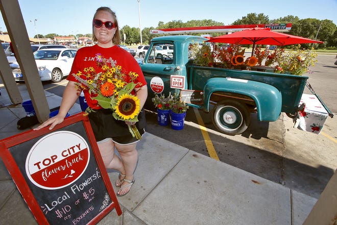 Abby Lanum, owner of Top City Flower Truck, has been selling flowers around Topeka since June. She sells flowers out of Fiona, a 1946 Ford F-100 that serves as an eye-catching piece for the business. [Chris Neal/The Capital-Journal]