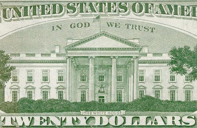 In 1956, President Dwight D. Eisenhower signs a law passed by the 84th Congress declaring “IN GOD WE TRUST” as the national motto of the United States. [MAGNUS MANSKE/WIKIMEDIA COMMONS/PUBLIC DOMAIN]