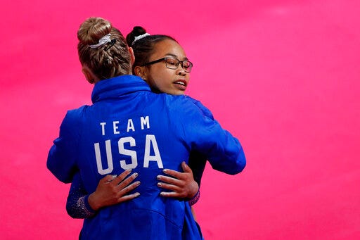 Morgan Hurd of the U.S. gets a hug from a coach after competing on floor in the women's gymnastics qualification and team final at the Pan American Games in Lima, Peru, Saturday, July 27, 2019. (AP Photo/Rebecca Blackwell)