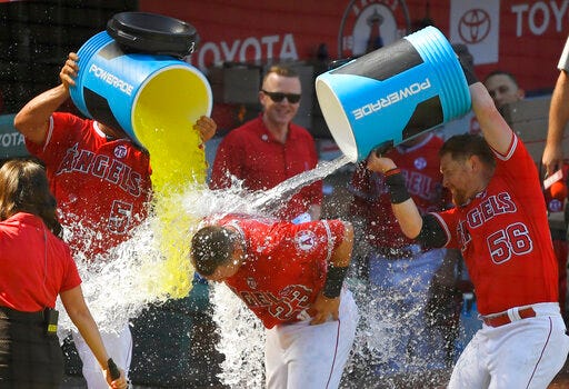 Los Angeles Angels' Matt Thaiss, center, is doused by Albert Pujols, left, and Kole Calhoun after hitting a walkoff home run during the ninth inning of a baseball game against the Baltimore Orioles, Sunday, July 28, 2019, in Anaheim, Calif. (AP Photo/Mark J. Terrill)