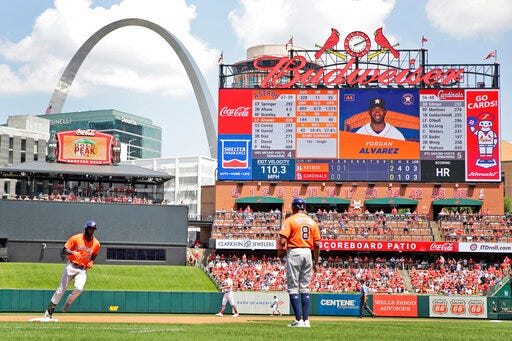 Houston Astros' Yordan Alvarez, left, rounds the bases after hitting a solo home run as third base coach Gary Pettis (8) watches during the third inning of a baseball game against the St. Louis Cardinals Sunday, July 28, 2019, in St. Louis. (AP Photo/Jeff Roberson)