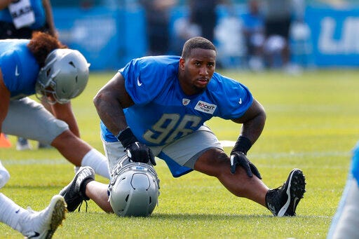 Detroit Lions defensive tackle Mike Daniels (96) stretches during NFL football practice in Allen Park, Mich., Sunday, July 28, 2019. (AP Photo/Paul Sancya)