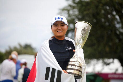 South Korea's Ko Jin-young poses for photographers with the trophy after winning the Evian Championship women's golf tournament in Evian, eastern France, Sunday, July 28, 2019. Ko won the championship by two shots with score of -15. (AP Photo/Laurent Cipriani)